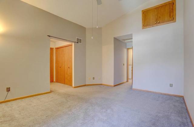 1870 Southpointe Ter Unit W1870, Eagan, MN 55122 - empty room featuring high vaulted ceiling, visible vents, light carpet, and baseboards