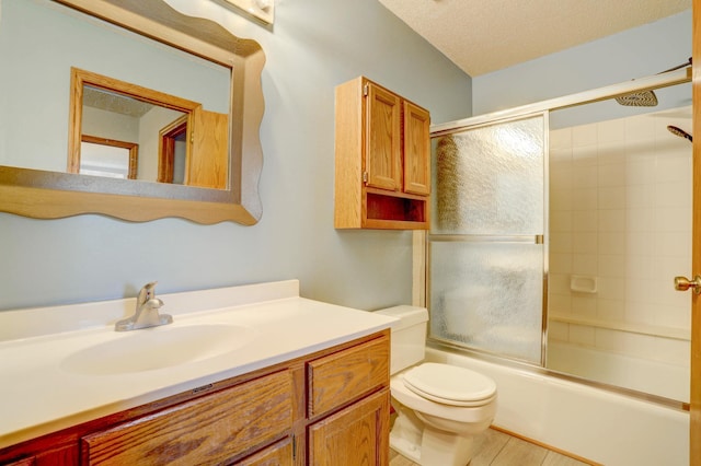 1870 Southpointe Ter Unit W1870, Eagan, MN 55122 - bathroom featuring vanity, a textured ceiling, shower / bath combination with glass door, and toilet