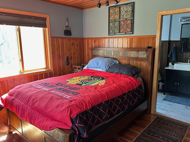 32305 W St, Breezy Point, MN 56472 - bedroom featuring a wainscoted wall, wood walls, wood finished floors, and wooden ceiling