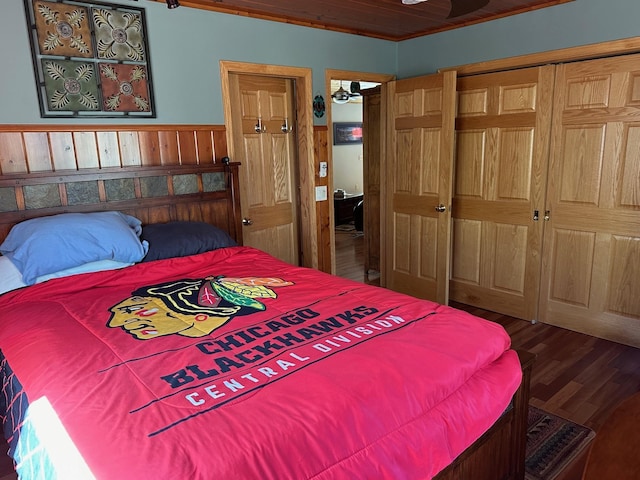 32305 W St, Breezy Point, MN 56472 - bedroom with wood finished floors, wood walls, a closet, and a wainscoted wall