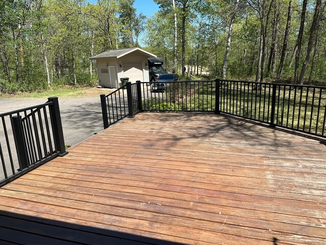 32305 W St, Breezy Point, MN 56472 - wooden terrace featuring a detached garage and an outdoor structure