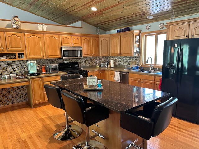 32305 W St, Breezy Point, MN 56472 - kitchen with appliances with stainless steel finishes, a sink, lofted ceiling, wooden ceiling, and backsplash