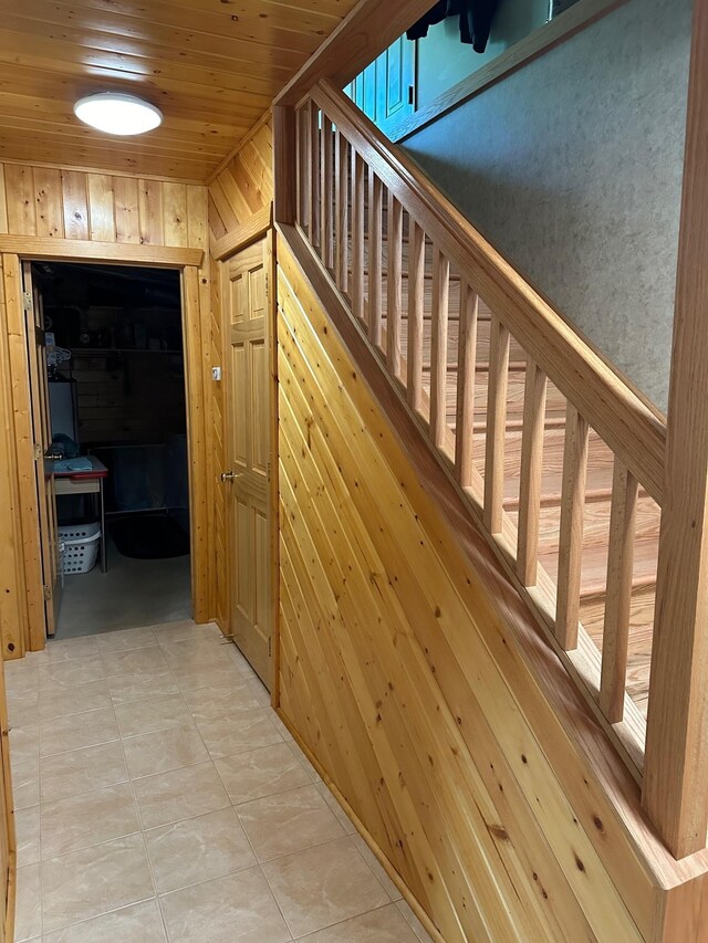 32305 W St, Breezy Point, MN 56472 - corridor featuring wooden walls, wooden ceiling, and light tile patterned floors