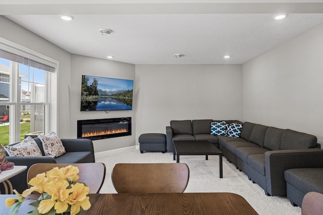 1144 Middlefield Rd, Medina, MN 55340 - carpeted living area featuring a glass covered fireplace, recessed lighting, and baseboards