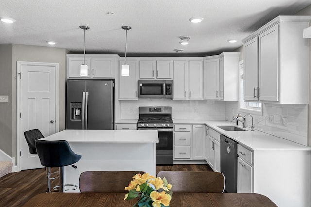 1144 Middlefield Rd, Medina, MN 55340 - kitchen featuring appliances with stainless steel finishes, a sink, dark wood finished floors, white cabinets, and recessed lighting