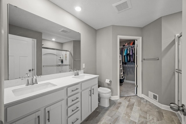 1144 Middlefield Rd, Medina, MN 55340 - bathroom with a shower stall, double vanity, toilet, baseboards, and a spacious closet