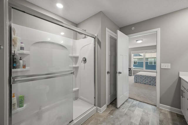 1144 Middlefield Rd, Medina, MN 55340 - ensuite bathroom with vanity, a stall shower, a textured ceiling, and baseboards