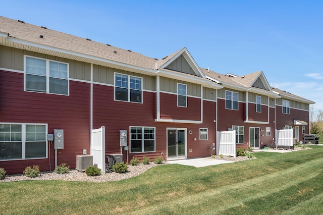 1144 Middlefield Rd, Medina, MN 55340 - back of property featuring board and batten siding, a lawn, central AC unit, a patio, and a shingled roof
