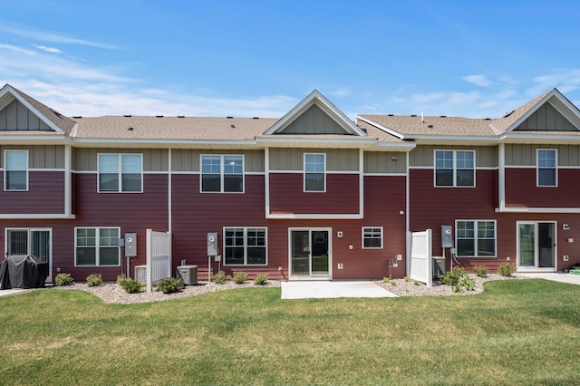 1144 Middlefield Rd, Medina, MN 55340 - back of property featuring board and batten siding, a lawn, a patio area, and central air condition unit