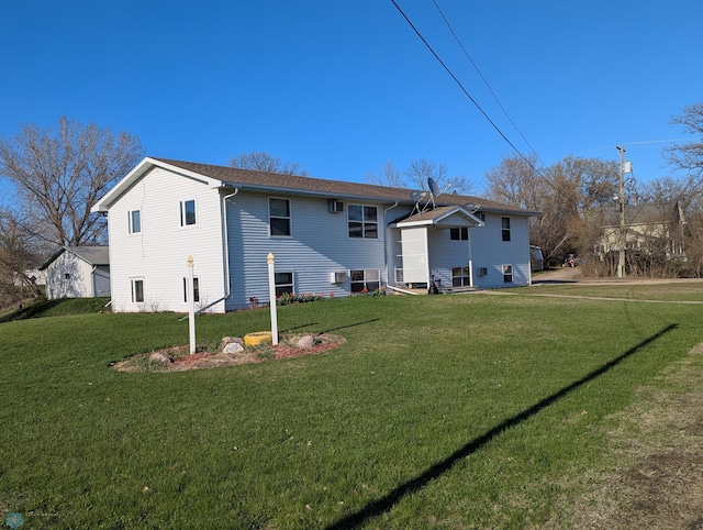 rear view of property with a lawn