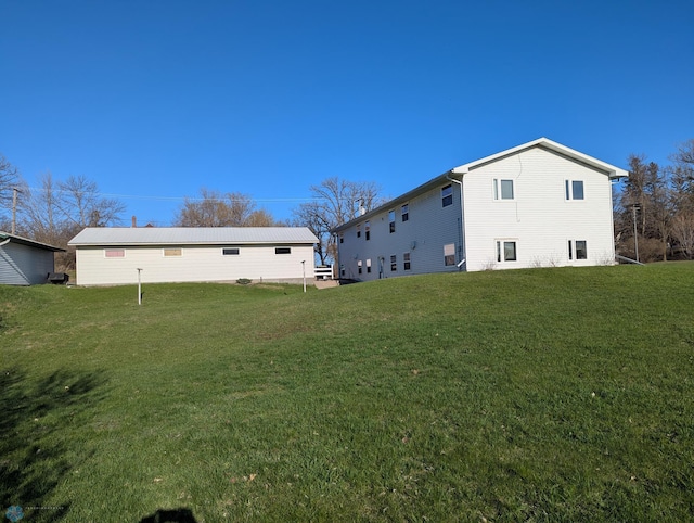 back of property with a lawn