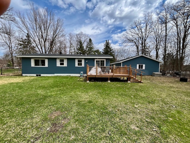 back of property featuring a yard and a wooden deck