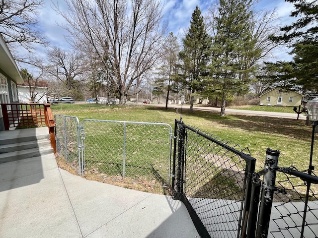 view of yard featuring fence and a gate