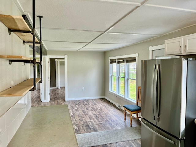 kitchen featuring white cabinets, open shelves, light wood finished floors, freestanding refrigerator, and visible vents