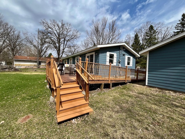 rear view of house featuring a lawn and a deck