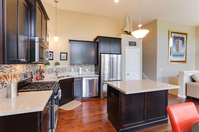 6942 151st St, Savage, MN 55378 - kitchen featuring appliances with stainless steel finishes, a sink, backsplash, and dark wood-type flooring