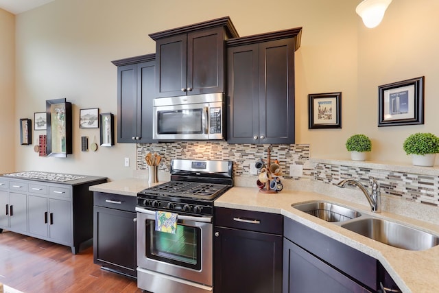 6942 151st St, Savage, MN 55378 - kitchen with stainless steel appliances, a sink, backsplash, and light countertops