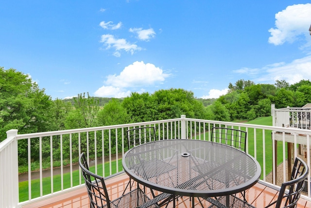 6942 151st St, Savage, MN 55378 - wooden terrace with outdoor dining space, a lawn, and view of wooded area