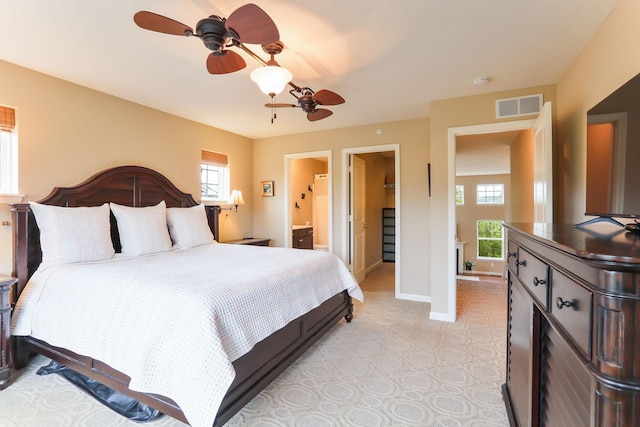 6942 151st St, Savage, MN 55378 - bedroom with multiple windows, baseboards, ensuite bath, and ceiling fan