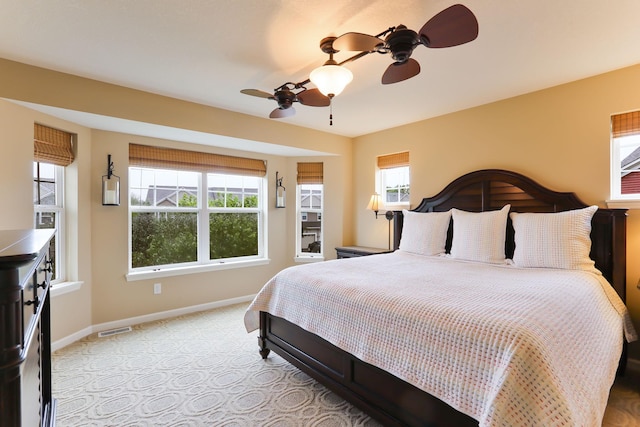 6942 151st St, Savage, MN 55378 - bedroom with multiple windows, baseboards, light colored carpet, and ceiling fan