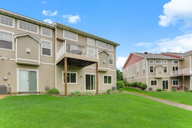 6942 151st St, Savage, MN 55378 - back of house with a balcony, a yard, and central AC unit