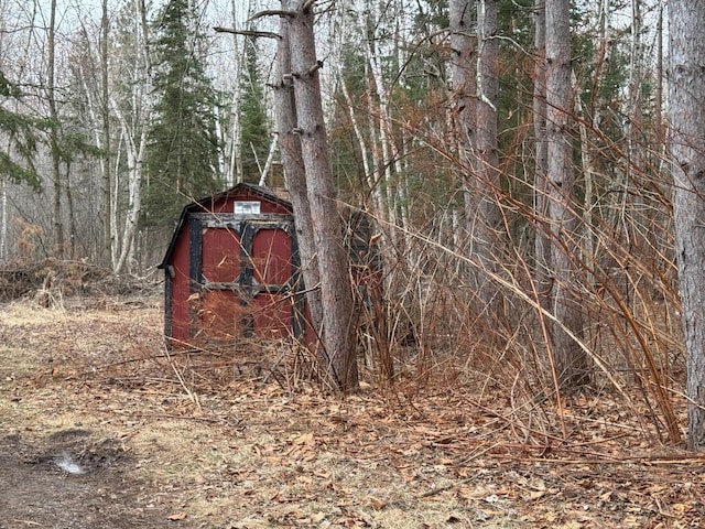 view of barn with a forest view