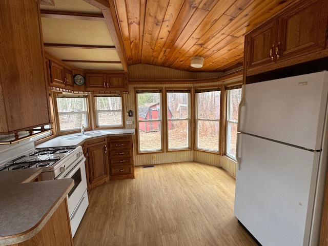 kitchen with wood ceiling, vaulted ceiling, a sink, white appliances, and light wood-style flooring