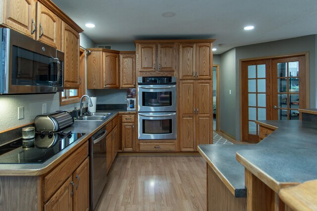 5360 Marohn Rd, Baxter, MN 56425 - kitchen featuring brown cabinetry, visible vents, light wood-type flooring, a sink, and appliances with stainless steel finishes