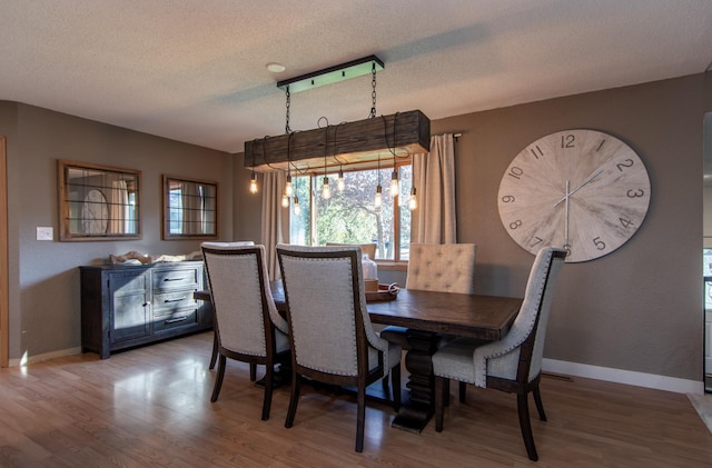 5360 Marohn Rd, Baxter, MN 56425 - dining room featuring plenty of natural light, baseboards, a textured ceiling, and wood finished floors