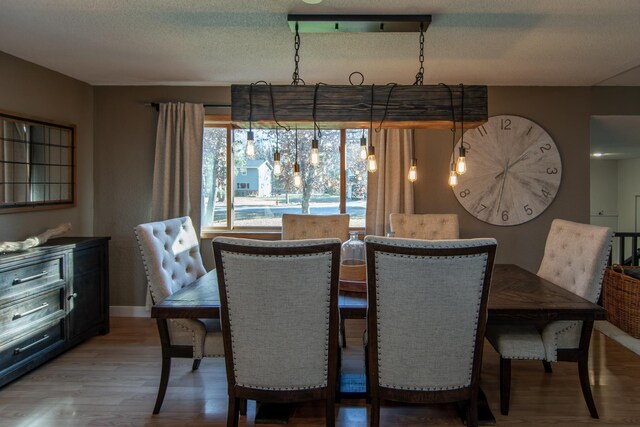 5360 Marohn Rd, Baxter, MN 56425 - dining room with baseboards, a textured ceiling, and wood finished floors