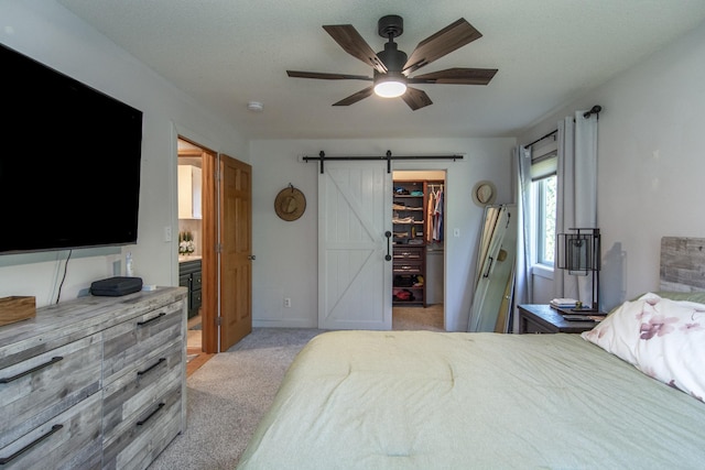 5360 Marohn Rd, Baxter, MN 56425 - bedroom featuring a closet, a walk in closet, light colored carpet, a barn door, and a ceiling fan