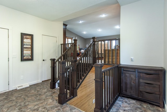 5360 Marohn Rd, Baxter, MN 56425 - staircase featuring visible vents, baseboards, vaulted ceiling, and stone finish floor