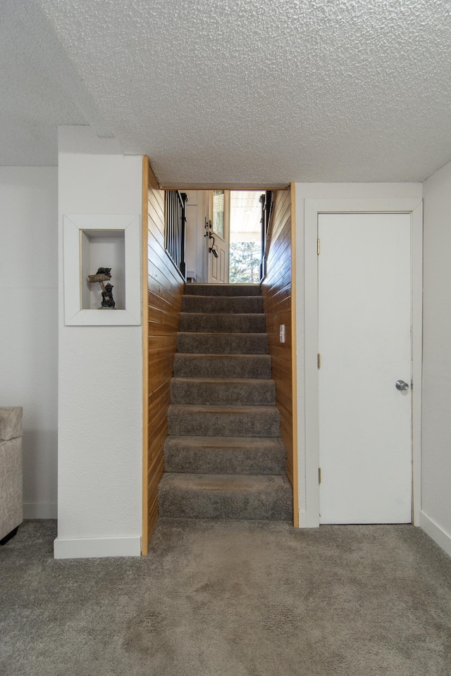 5360 Marohn Rd, Baxter, MN 56425 - stairs with carpet floors, a textured ceiling, and wood walls