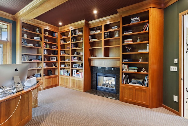 carpeted office with baseboards, ornamental molding, and a premium fireplace
