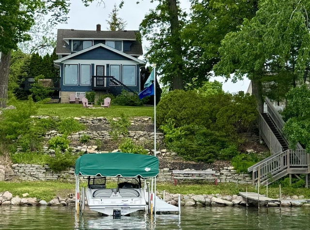 view of dock featuring stairs, a water view, and boat lift