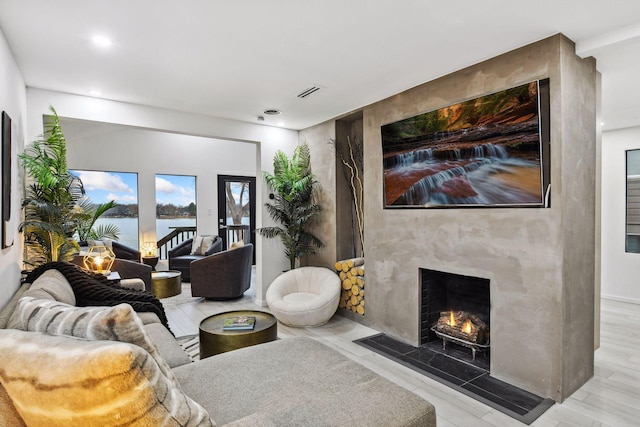 living room featuring recessed lighting, visible vents, and a fireplace