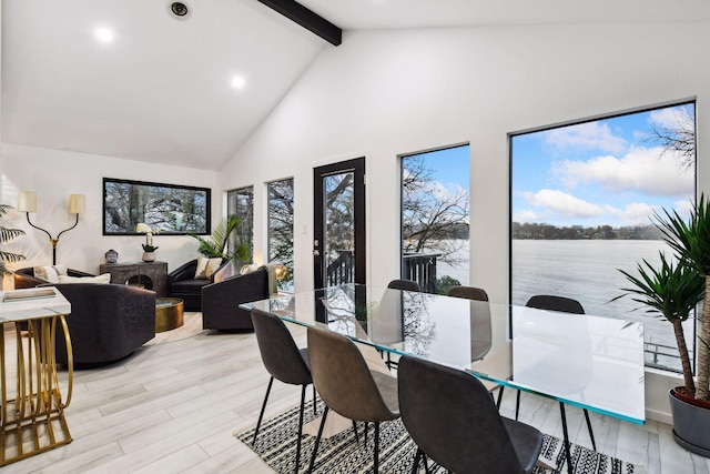 dining room featuring beamed ceiling, high vaulted ceiling, recessed lighting, a water view, and light wood finished floors