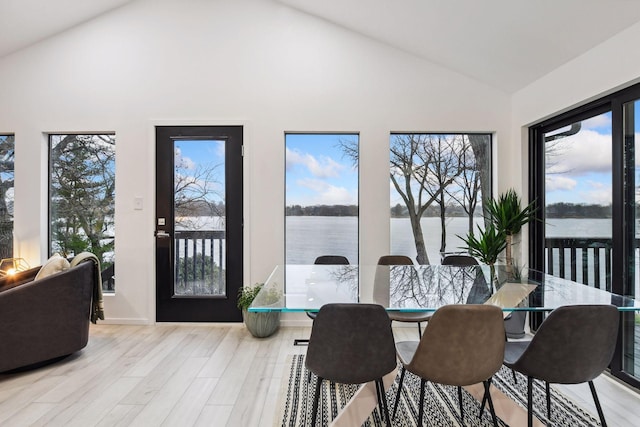 sunroom / solarium featuring a water view