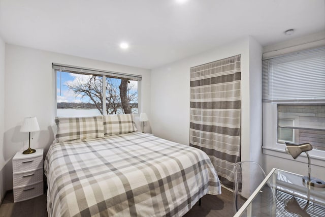 bedroom with recessed lighting and wood finished floors