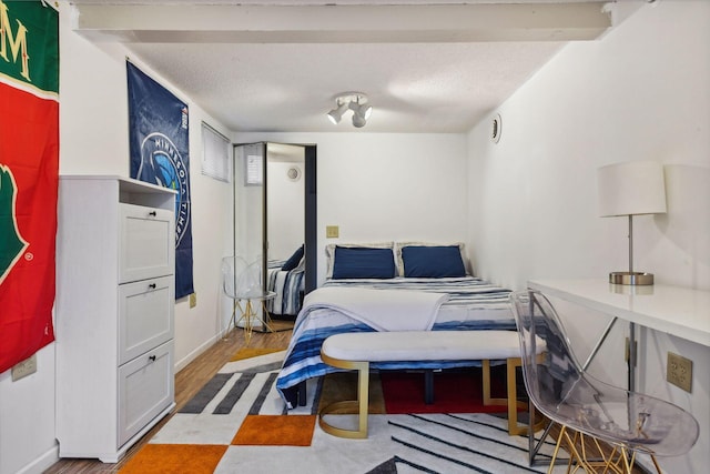bedroom featuring baseboards and wood finished floors