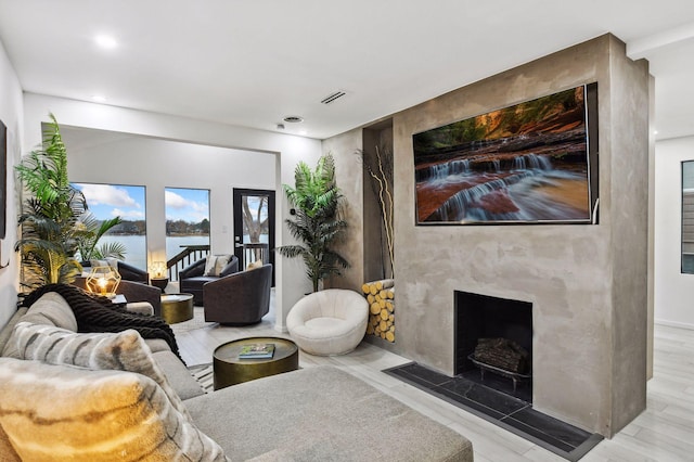 1733 Gull Ln, Mound, MN 55364 - living area with a premium fireplace, recessed lighting, and a water view
