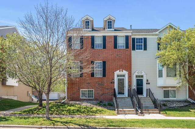 townhome / multi-family property featuring brick siding