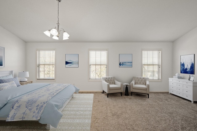 bedroom with carpet flooring, baseboards, and a notable chandelier