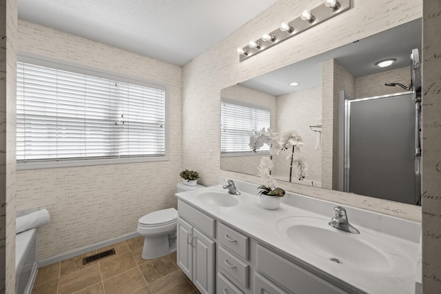 bathroom featuring a shower stall, a sink, and a healthy amount of sunlight