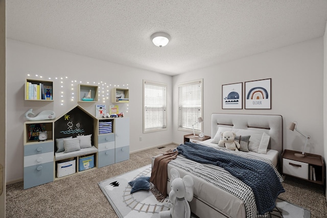 bedroom featuring baseboards, a textured ceiling, and carpet