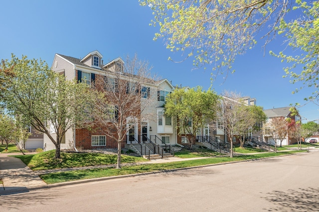 multi unit property with brick siding and a residential view