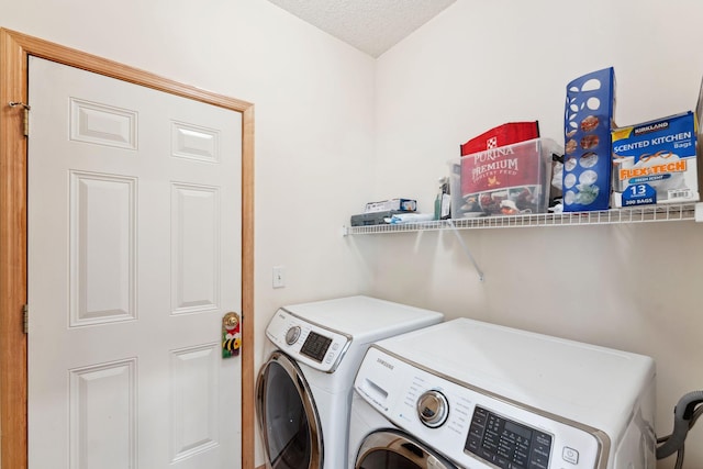 clothes washing area with a textured ceiling, laundry area, and independent washer and dryer