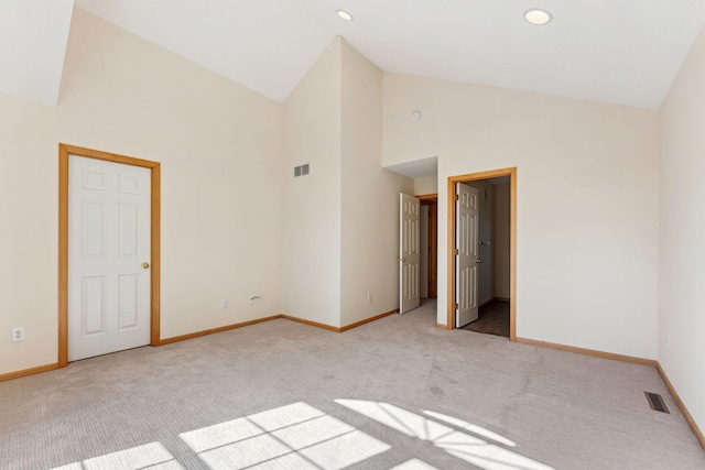 carpeted empty room with recessed lighting, high vaulted ceiling, visible vents, and baseboards