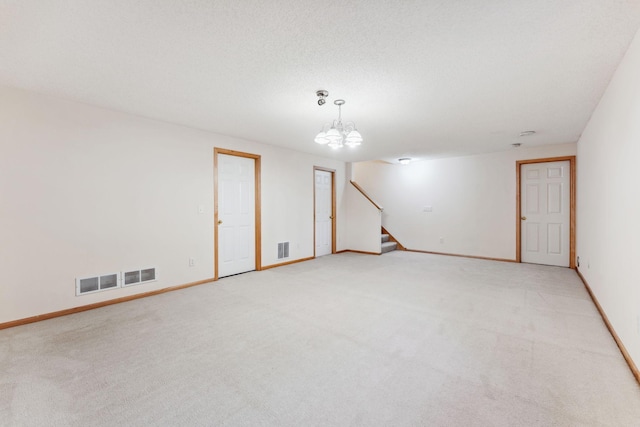 empty room with visible vents and light colored carpet