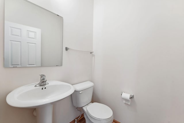 half bathroom with a sink and toilet